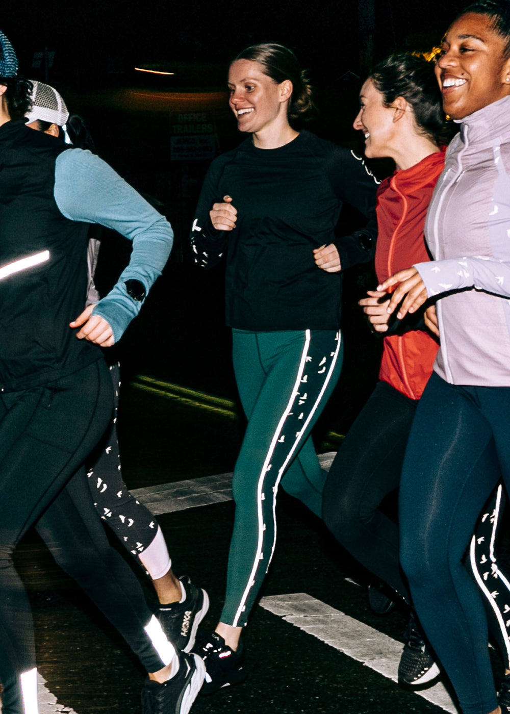 Glow Reflective Running Tights in Juniper Green, side view at night showing reflective details