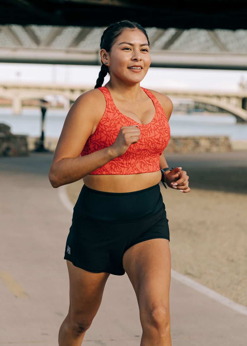 Woman running outside in High Rise Roga 4" Running Shorts and Oiselle sports bra