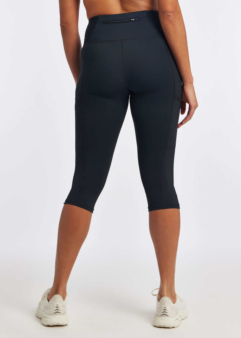 Woman wearing black running knickers in size 4, back view