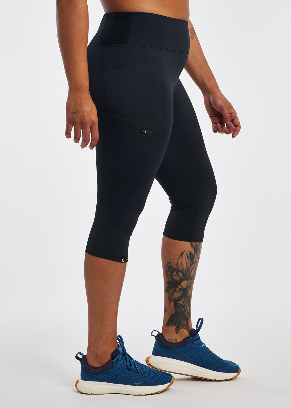 Woman wearing black running knickers in size 12, side view