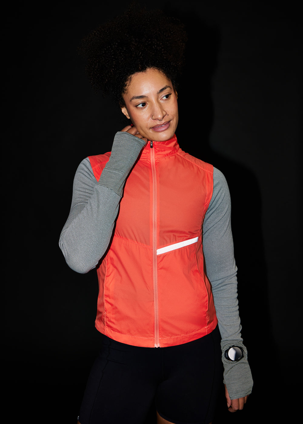 Vigor Packable Running Vest in Alpenglow Orange, front view with reflective accents